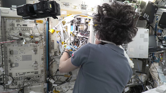 Astronaut maintaining space station water system