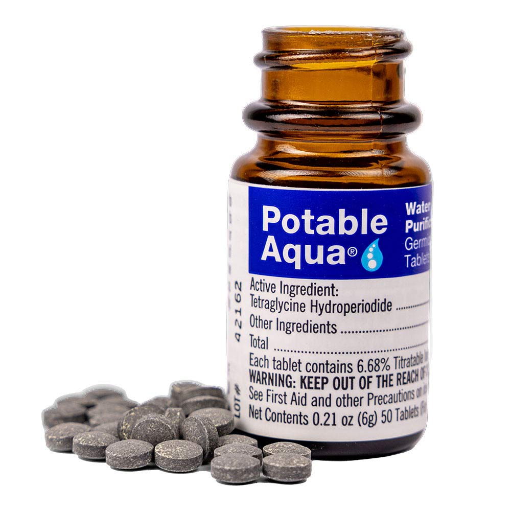 Potable Aqua water purification tablets bottle with pills spilled
